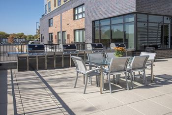 Outdoor community terrace with 4 grilling stations and an outdoor dining area.